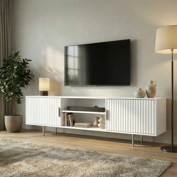 [White] White 180cm TV unit with vertical fluted side doors and central open shelf, TV mounted, lit floor lamp on right.