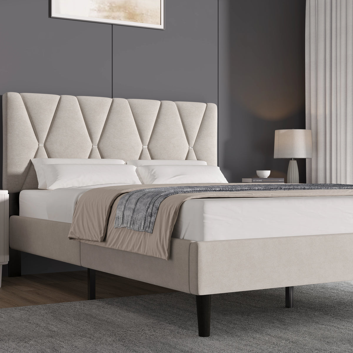 [Double | Beige] Diamond-pattern tufted bed centred between bedside tables with decorative lamps