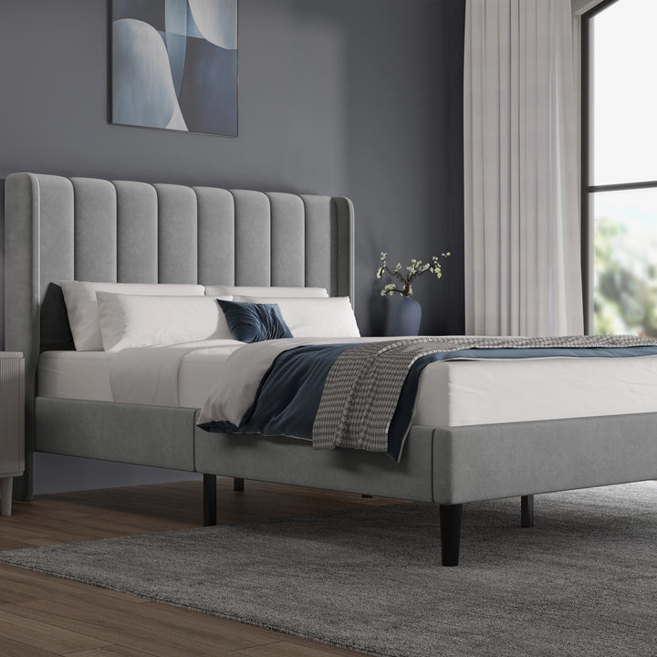 [Double | Light Grey] Side angle of velvet bed with vertical channel-tufted headboard and low footboard on dark legs