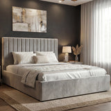 [Light Grey | Small Double] Vertical ottoman bed in white linen seen from corner, chandelier above and pampas in vase