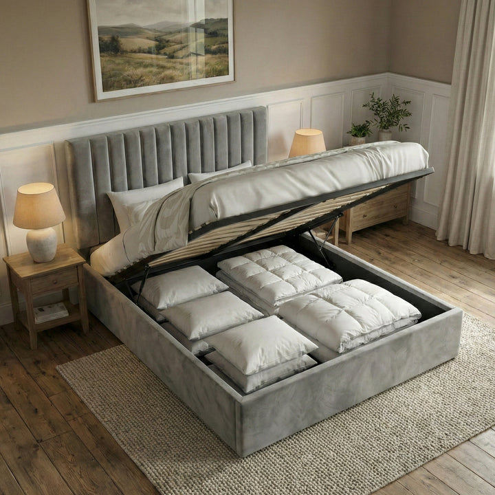 [Grey | Double] vertical ottoman bed open on gas struts revealing white pillows stacked inside the storage cavity