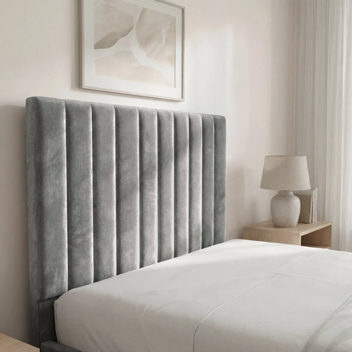 [Grey | Single] bed frame headboard close-up displaying vertical pleats with abstract leaf art visible in background
