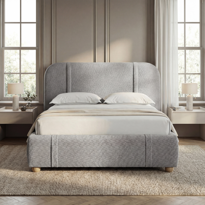 [Double | Grey]  Front view of wingback bed centred between white nightstands with matching  lamps in taupe panelled room