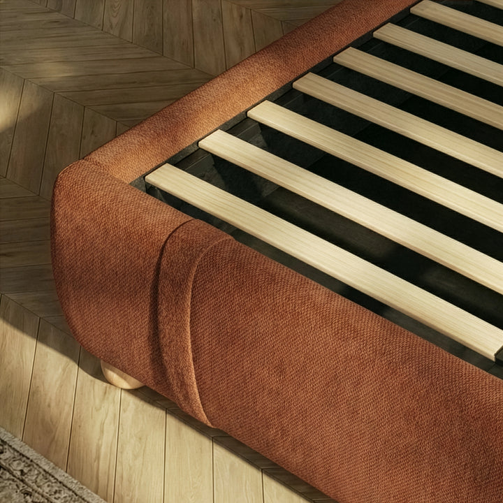 [Double | Orange] Bed frame base showing wooden slats and rounded padded footboard corner from above