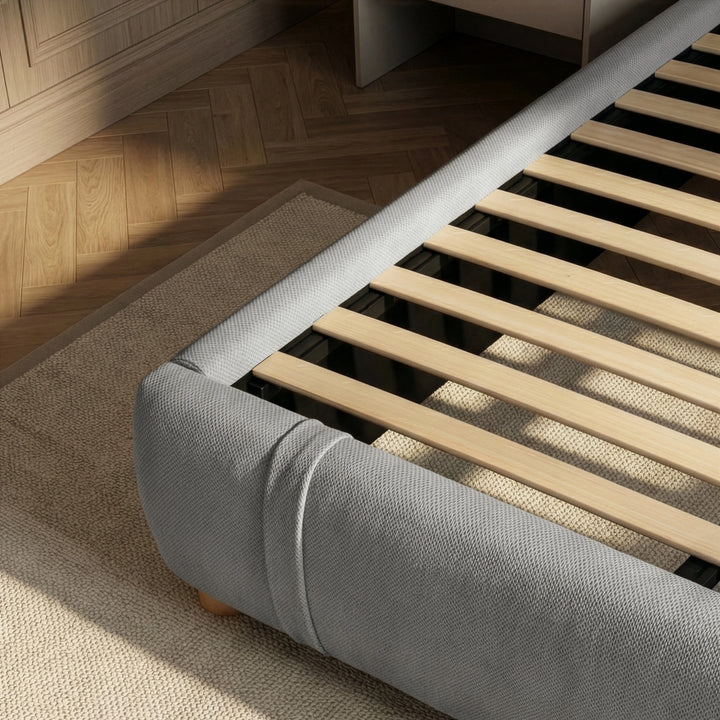 [King | Grey] Bed frame base detail with wooden slats and rounded padded footboard on jute rug
