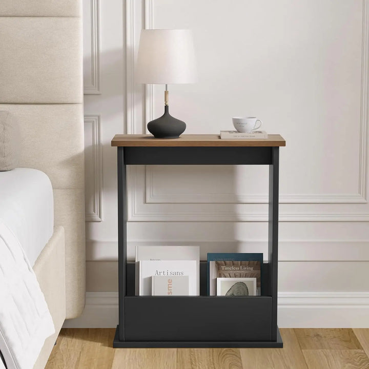 [Walnut + Black] Narrow Side Table used as bedside nightstand with table lamp, ceramic vase, coffee cup, book, and magazines stored below