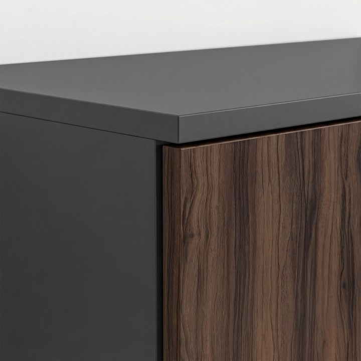 [Walnut] Top corner detail of walnut and grey wardrobe highlighting layered panel construction and finish contrast