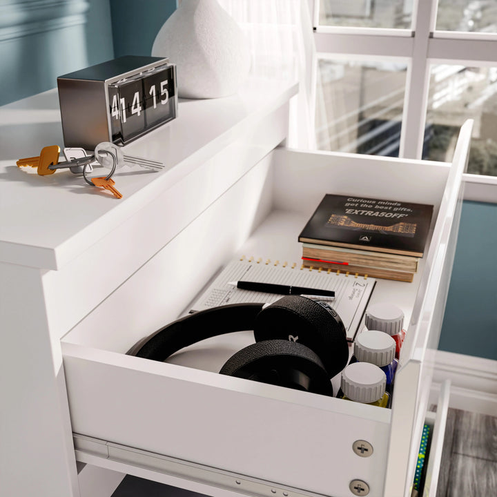 [Black] high gloss 3 drawer chest close-up of open top drawer with black headphones hardback book and pen