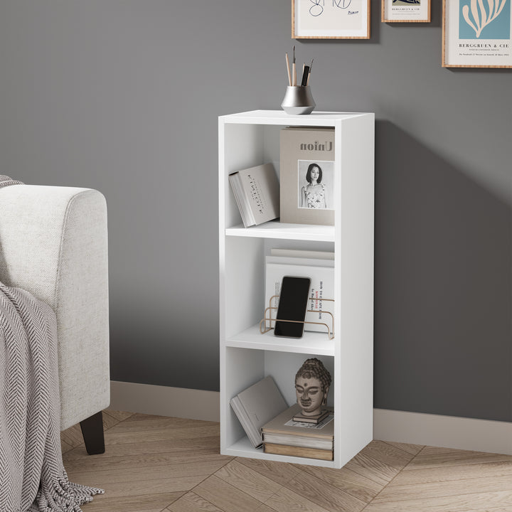[3 Shelf | White] console-height white-faced bookcase set behind chair by ivory wall