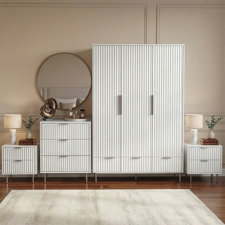 [White] four piece bedroom furniture set, including a wardrobe, dresser, and two bedside tables, placed in a room