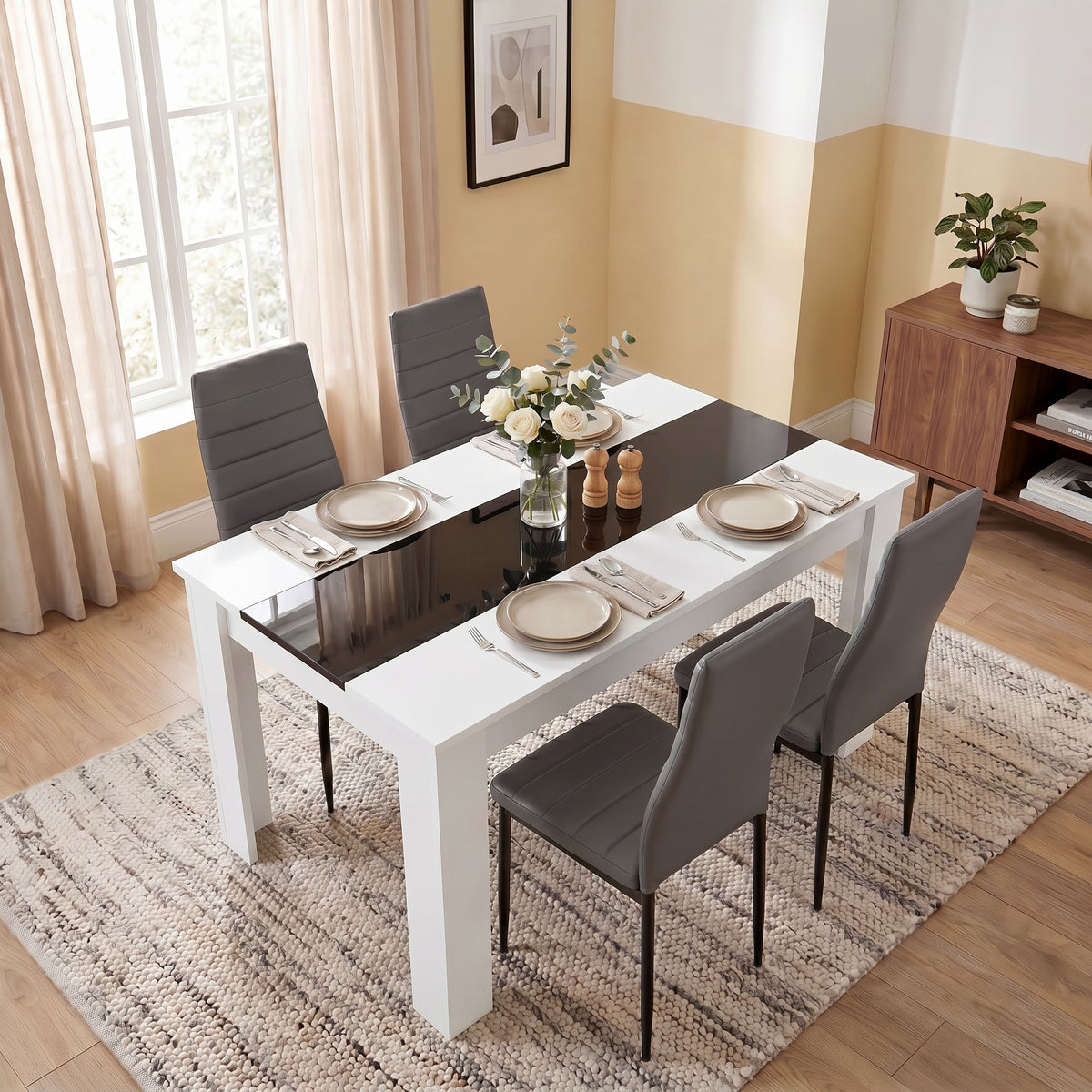 [4 Seater | Grey] White & Black Gloss 4-6 Seater Dining Table viewed from above with four grey faux-leather chairs and neutral place settings on a woven rug