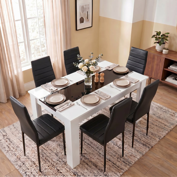 [6 Seater | Black] White & Black Gloss 4-6 Seater Dining Table photographed from an elevated angle with six black chairs, full place settings and a rose centrepiece