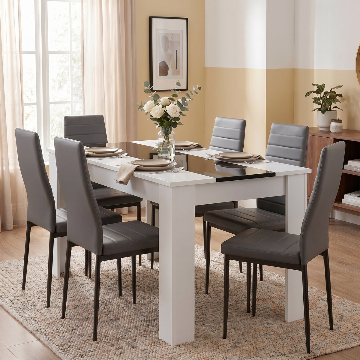[6 Seater | Grey] White & Black Gloss 4-6 Seater Dining Table set with six grey faux-leather chairs and a white rose centrepiece in a warm-toned dining room