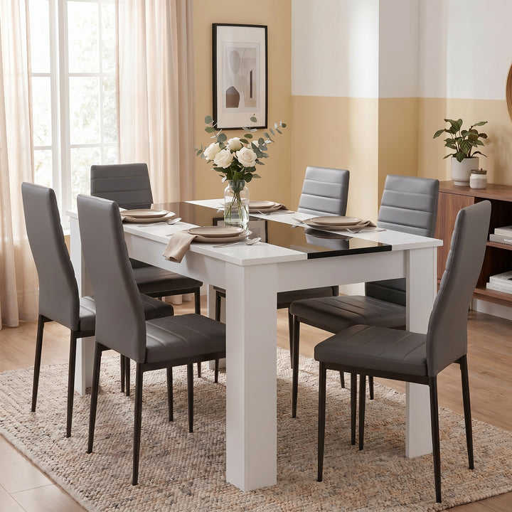 [6 Seater | Grey] White & Black Gloss 4-6 Seater Dining Table set with six grey faux-leather chairs and a white rose centrepiece in a warm-toned dining room
