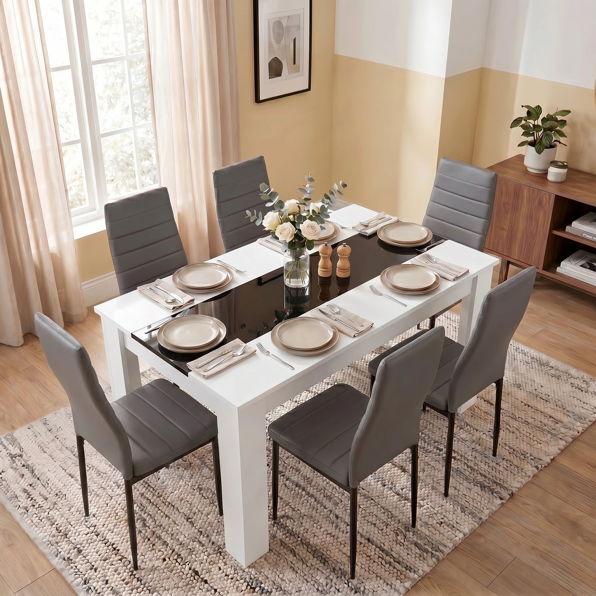 [6 Seater | Grey] White & Black Gloss 4-6 Seater Dining Table viewed from above with six grey faux-leather chairs and six neutral place settings on a woven rug