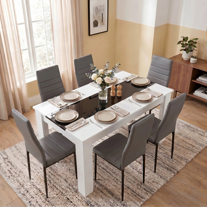 [6 Seater | Grey] White & Black Gloss 4-6 Seater Dining Table viewed from above with six grey faux-leather chairs and six neutral place settings on a woven rug
