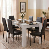 [6 Seater | Black] White & Black Gloss 4-6 Seater Dining Table set with six black faux-leather chairs on a woven rug in a warm, light-filled dining room