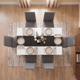 [6 Seater | Grey] White & Black Gloss 4-6 Seater Dining Table seen from directly above with six grey chairs, six beige place settings and a floral centrepiece