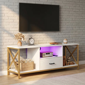 [White] Calvera TV unit angled view showing purple LED shelf lighting, gold X-frame legs, drawer and open shelving