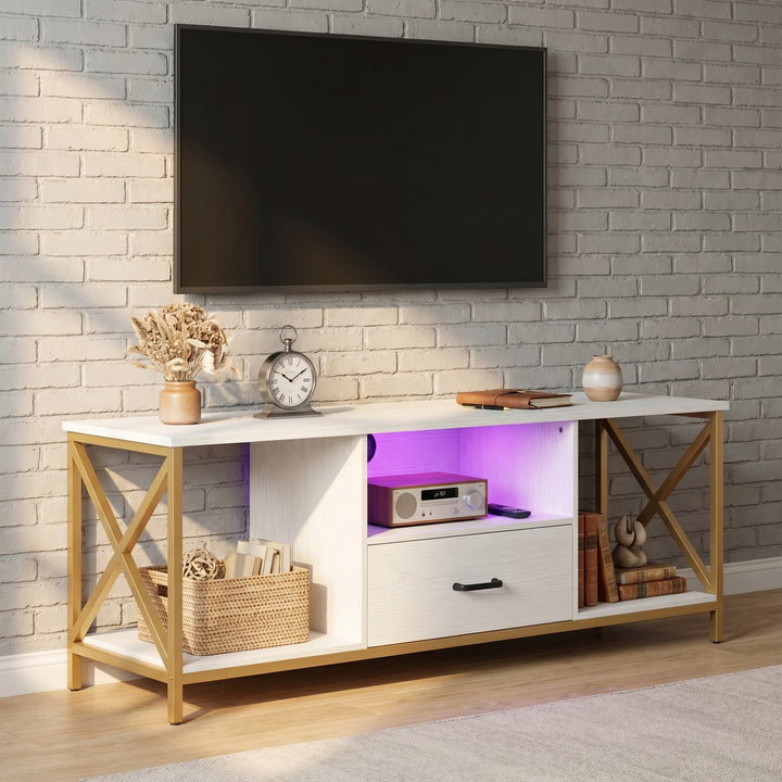 [White] Calvera TV unit angled view showing purple LED shelf lighting, gold X-frame legs, drawer and open shelving