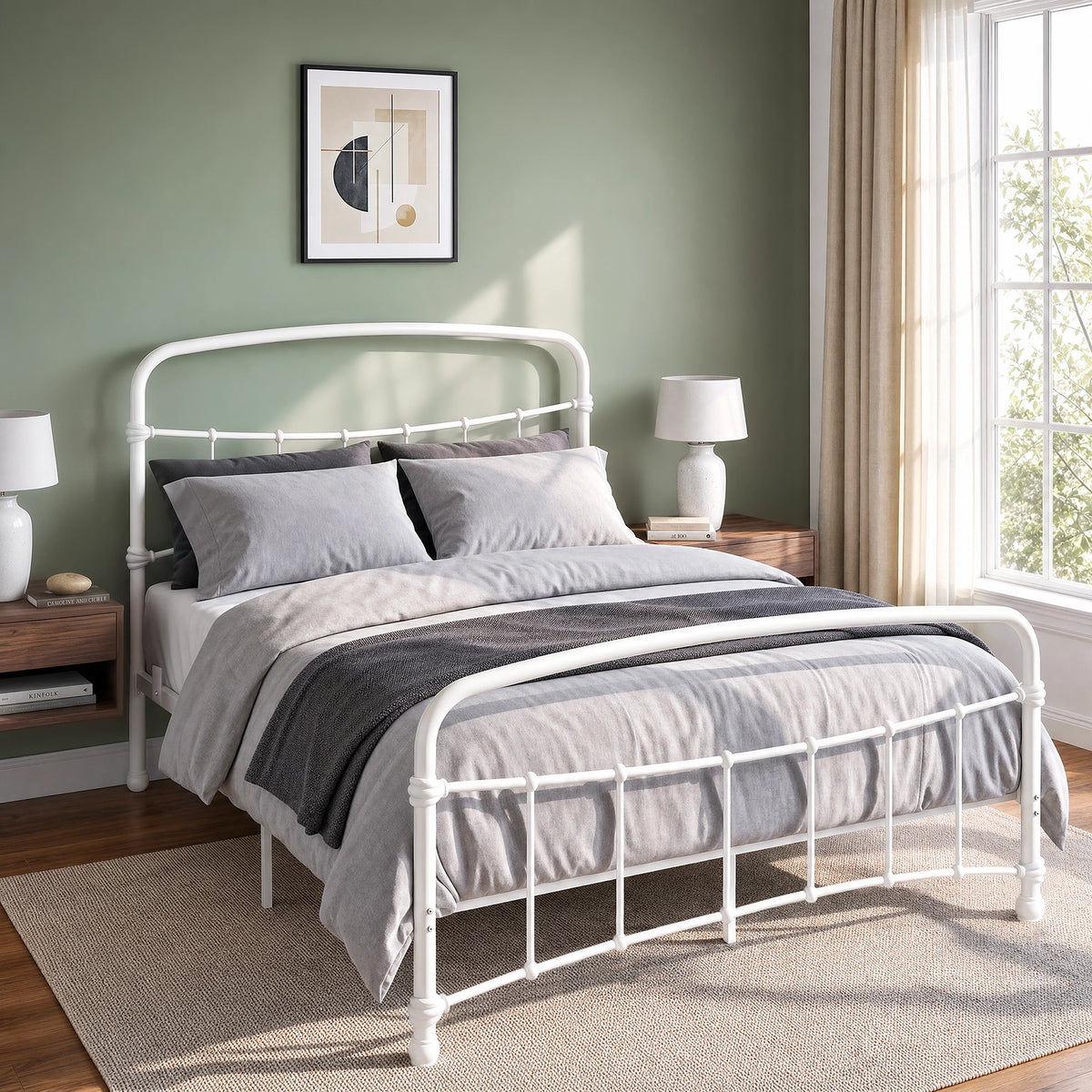 [White | Double] Close view of the white curved front rail, vertical bars and white bedding beside a small table.