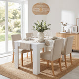 [120 cm | White] 4 and 6 Seater Dining Table Rectangle fully arranged with four beige fabric chairs and a center bouquet.