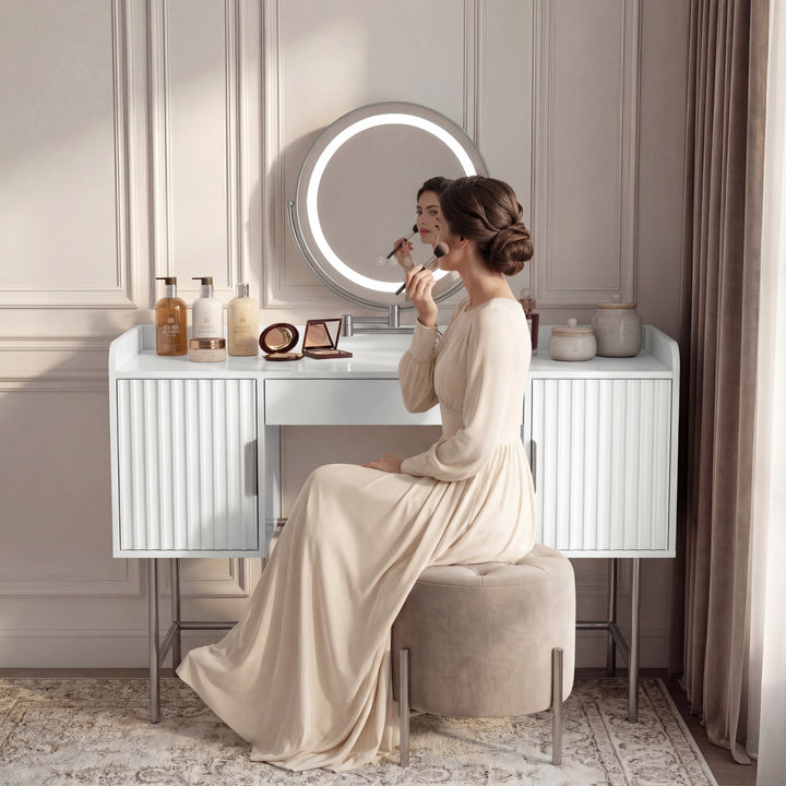 lifestyle of the white fluted vanity with seated woman doing makeup, round LED mirror centred above the drawer