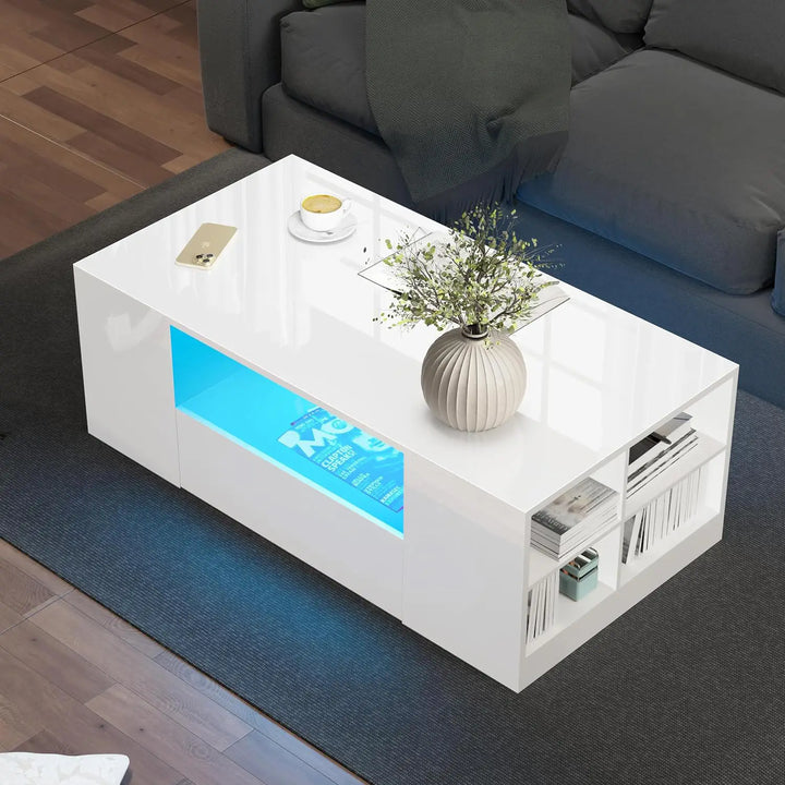[White] High Gloss Coffee Table with LED overhead view showing blue LED central shelf, open end cube shelving with magazines, ribbed vase
