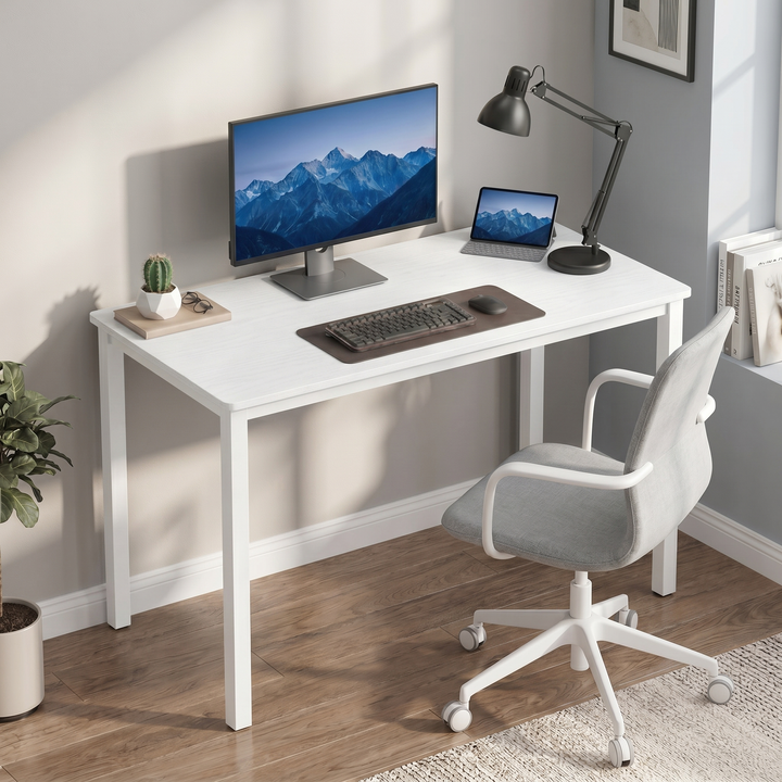 [100 x 50 cm] Home Office Desk 100cm angled in grey home office with monitor, tablet, keyboard, black lamp, cactus, and grey upholstered office chair on wood floor