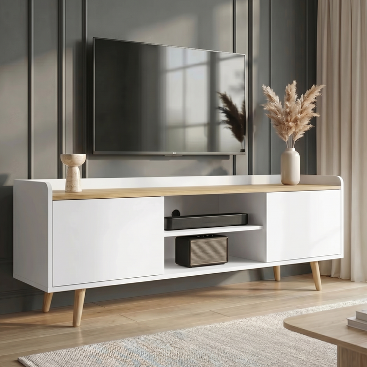 [White] Larvik White TV Unit with Shelves styled against a dark grey panelled wall with a TV above, open centre shelving, two side cabinets and tapered oak legs