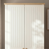 [White] Linra 2 door wardrobe close-up of oak top edge, tongue-and-groove door panels, and round wooden knob hardware in natural light