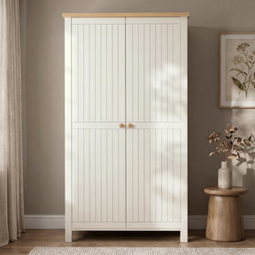 [White] 2 Door wardrobe with oak wood top and in a room with a plant and vase on a small table