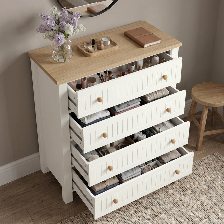 [White] Linra White Painted 4 Piece Bedroom Set four-drawer chest with all drawers open displaying cosmetics, folded clothing, accessories and small items on the oak top surface