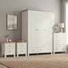 [White] Linra White Painted 4 Piece Bedroom Set arranged against a light grey wall two bedside tables