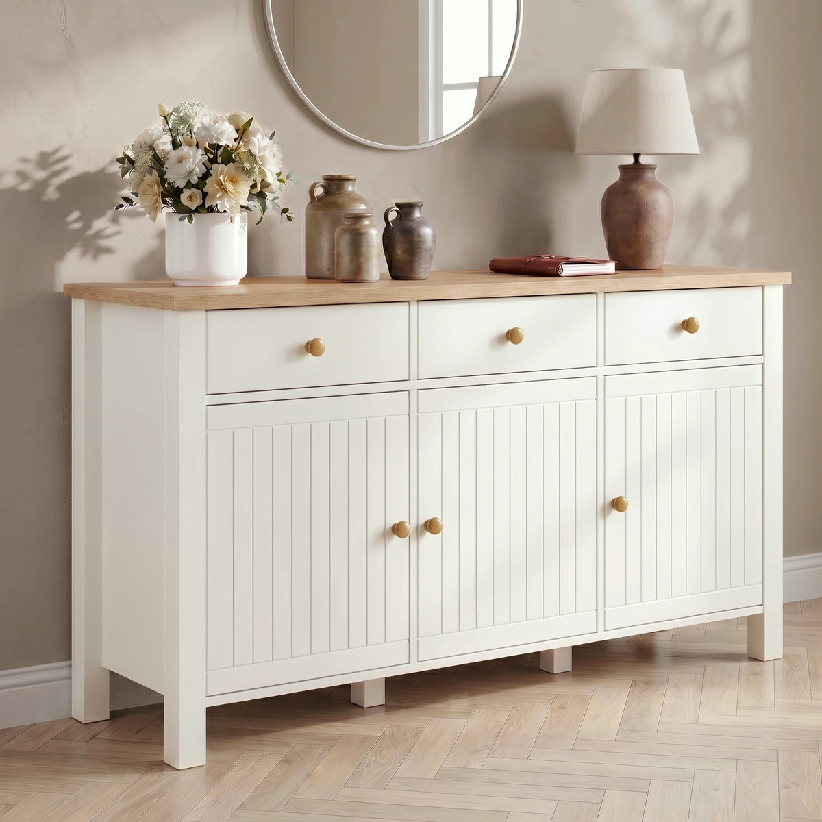 [White] sideboard with wooden top, decorative items, and a mirror on a beige wall
