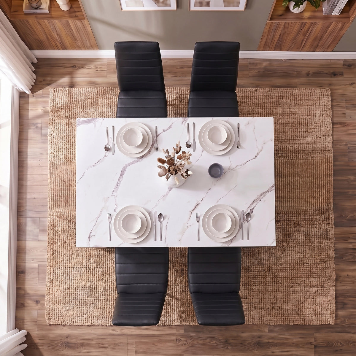 [4 Seater | Black] overhead shot of white marble dining table with four black chairs and plates setting
