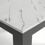 [White Marble] Close-up of the marble-effect tabletop corner and thick grey L-shaped leg; fine grey veining crosses the top.