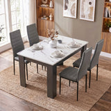 [4 Seater | Grey] White Marble 4 Seater Dining Table and Chairs Set shown from a high angle on a woven rug.