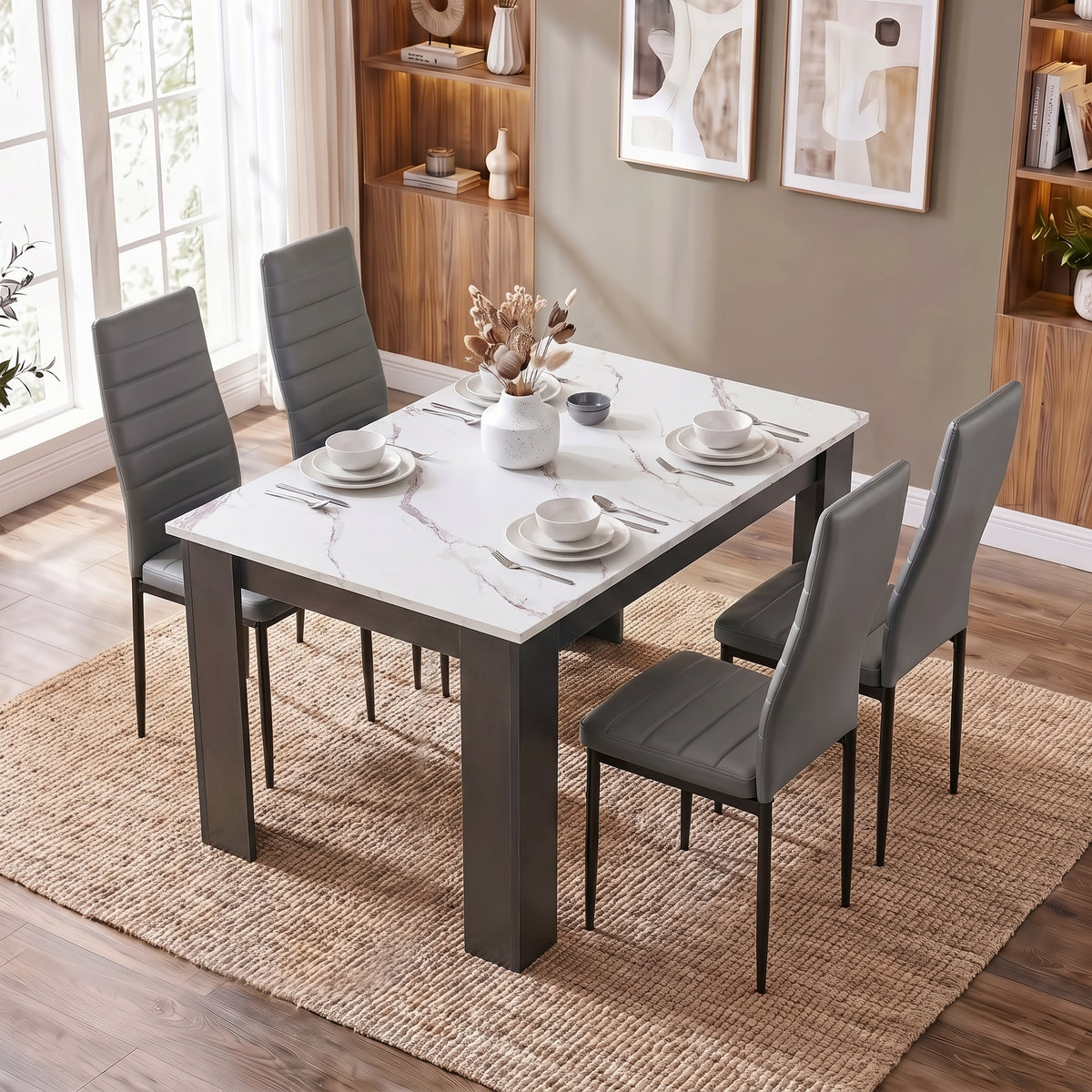 [4 Seater | Grey] White Marble 4 Seater Dining Table and Chairs Set shown from a high angle on a woven rug.