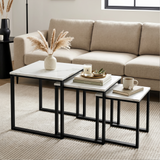 [White Marble] Stackora nest of 3 tables styled as centre table in living room with pampas grass, candle, and mug on beige sofa