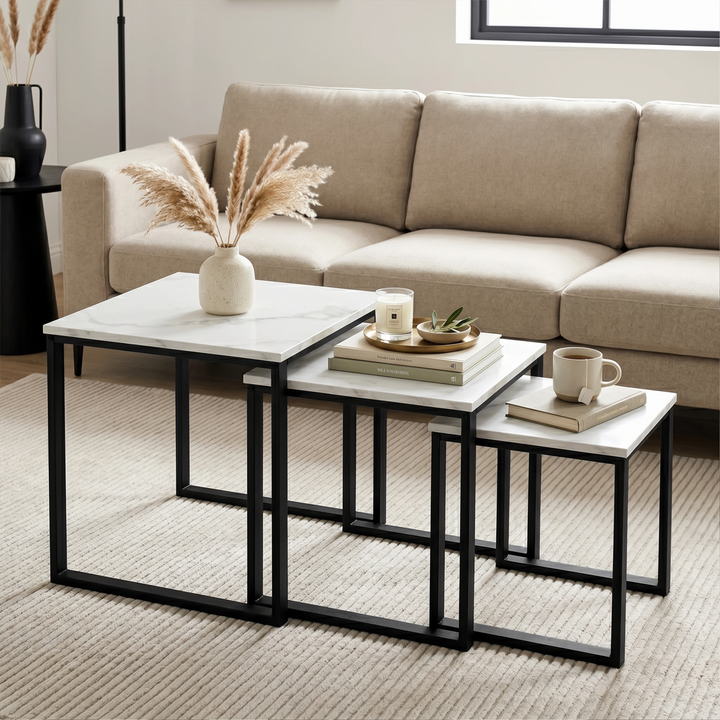 [White Marble] Stackora nest of 3 tables styled as centre table in living room with pampas grass, candle, and mug on beige sofa