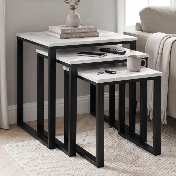 [White Marble] Stackora nest of 3 tables used as side and coffee tables in living room with books, mug, remote, and keys