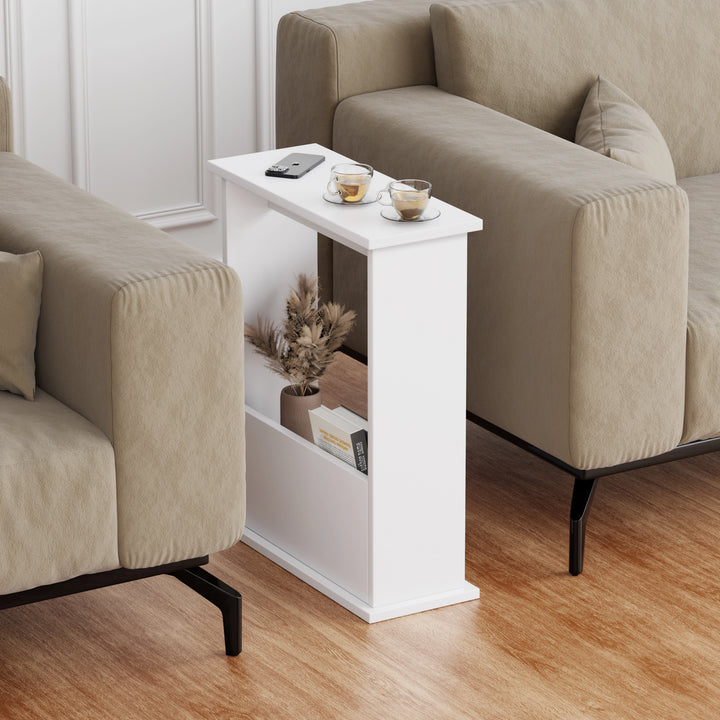 [White] side table with storage shown between two sofas, slim frame with books in front and cup on top