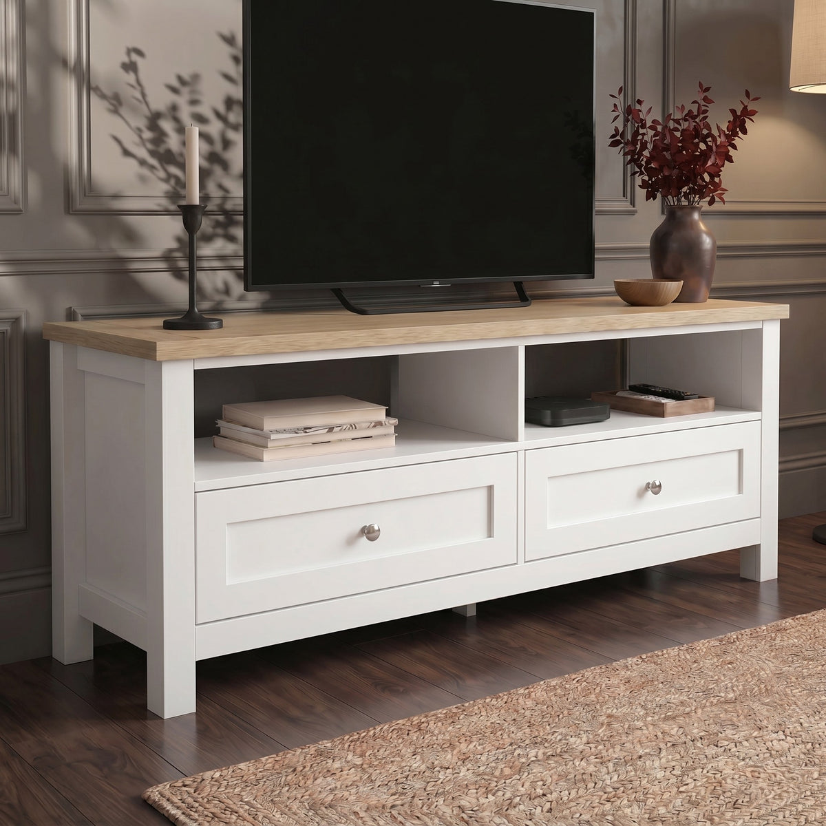 [White] Oskara White Painted TV Unit with Storage at a three-quarter angle showing the oak top surface, two open cubbies with media accessories, and paired shaker drawers