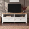 [White] Oskara White Painted TV Unit with Storage shown front-on in a grey panelled room with a TV, open shelves holding books and a media box, and two shaker-style drawers below