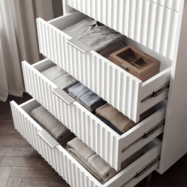 [White] flutrina chest of drawers with multiple drawers extended to display internal storage capacity