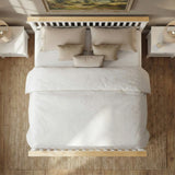 [White + Pine | Double] Overhead view of a neatly made bed with white bedding and beige pillows, set in a bedroom with a light wood frame, white nightstands, lamps, and a woven rug.