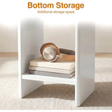 [White] Small Round Side Table with Shelf Living Room close-up of lower storage shelf between panel legs holding books and headphones on beige rug