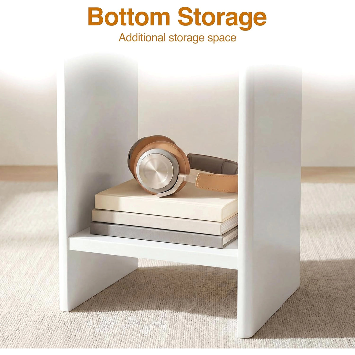 [White] Small Round Side Table with Shelf Living Room close-up of lower storage shelf between panel legs holding books and headphones on beige rug
