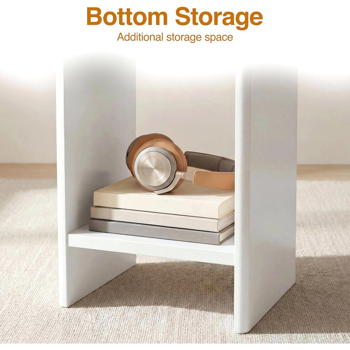 [White] Small Round Side Table with Shelf Living Room close-up of lower storage shelf between panel legs holding books and headphones on beige rug